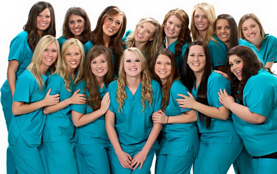 Jessie Boeckmann with her dental hygiene school classmates, group portrait in teal scrubs